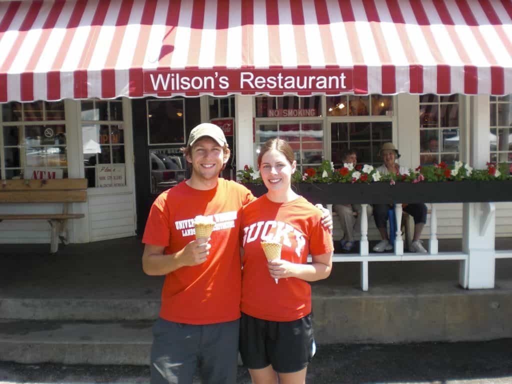 couple standing in front of "Wilson's Restaurant" sign