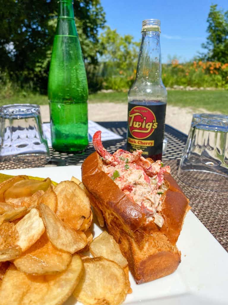 a plate with chips and a lobster roll