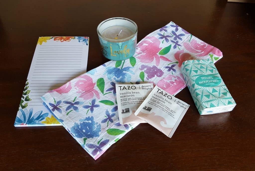 shower favors including a candle, tea towel, kleenex, tea,  and notepad