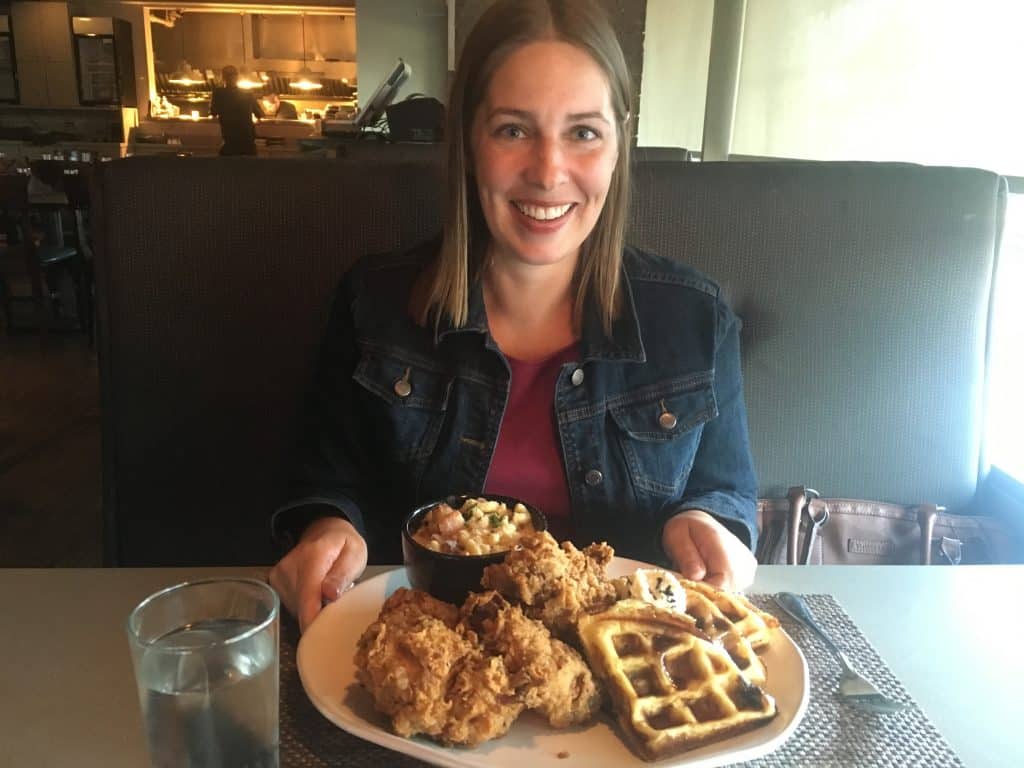 Woman with plate of chicken and waffles