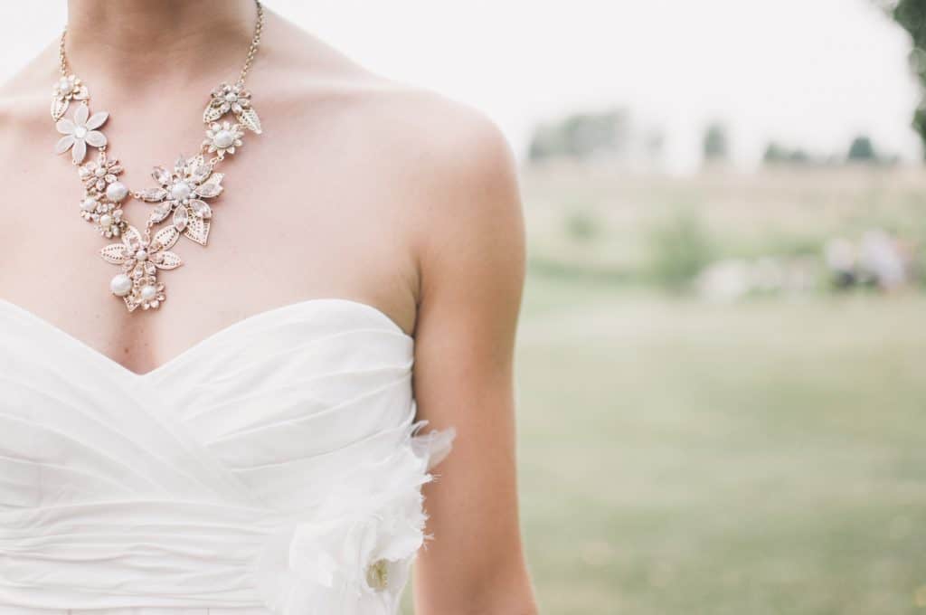 bride in a strapless wedding gown and statement necklace