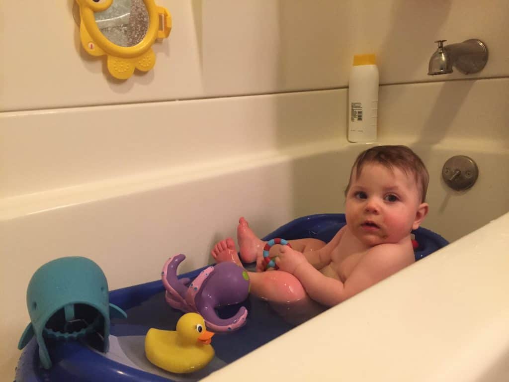 baby in baby bathtub in a regular bathtub