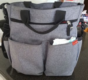 Front view of diaper bag with pockets and handles