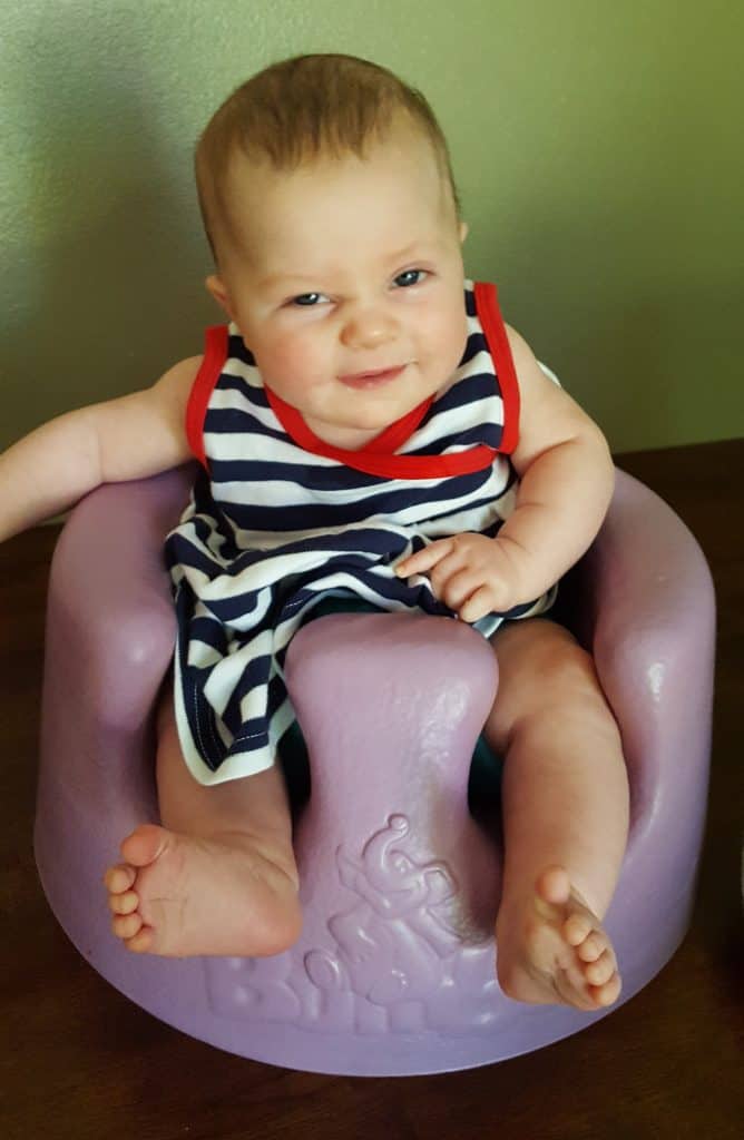 baby in a purple Bumbo chair