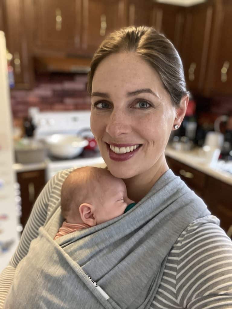 author wearing baby in a wrap