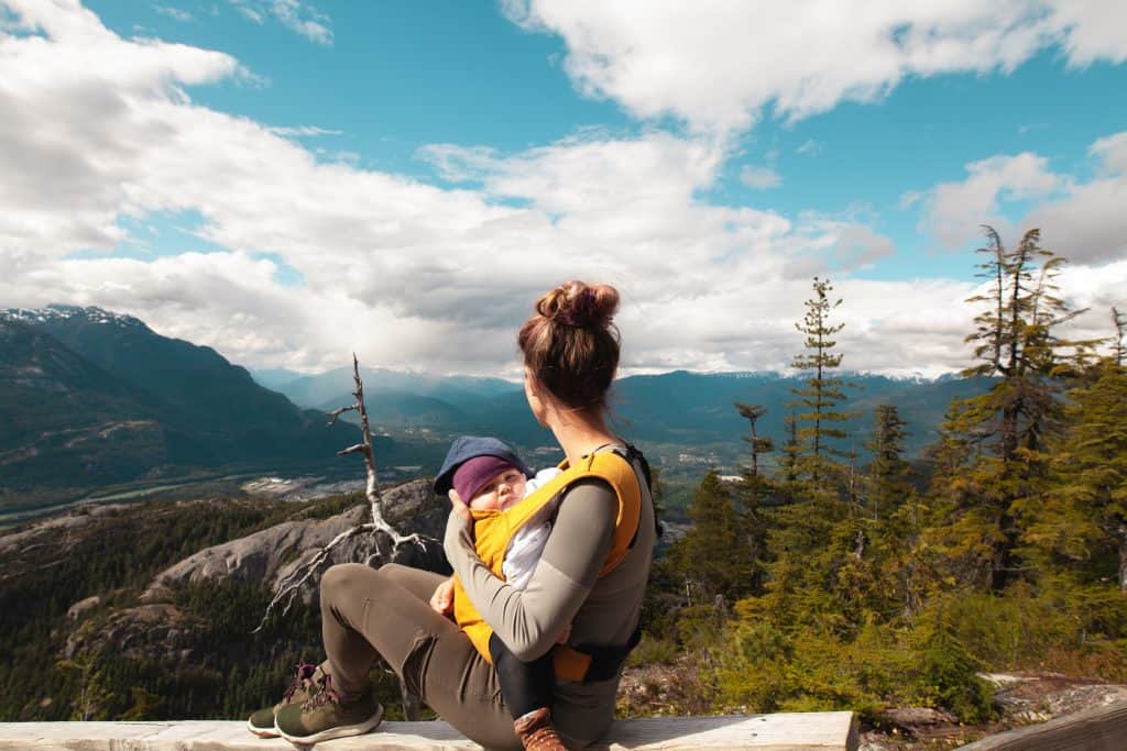 woman hiking with baby in a front carrier