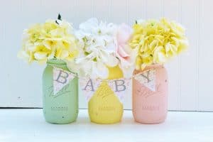 Pinterest inspiration picture of three painted mason jars with flowers in them and a small "baby" sign across them.