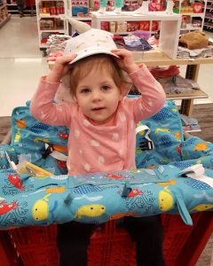 toddler sitting in shopping cart cover