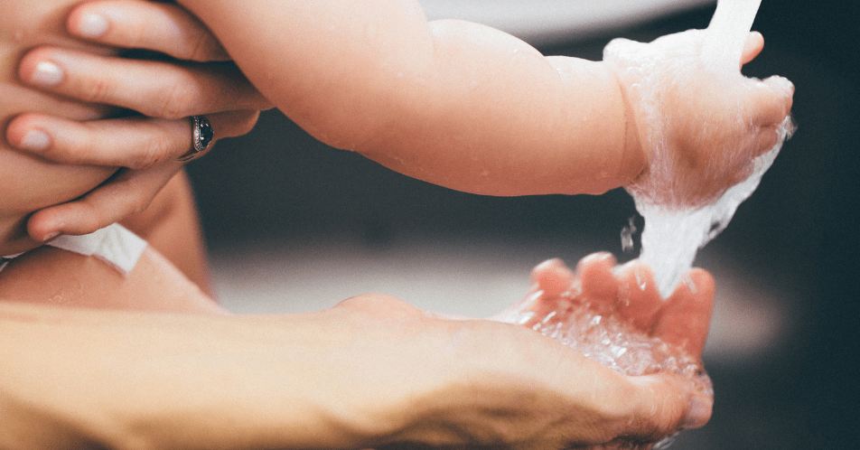 baby and adult washing hands