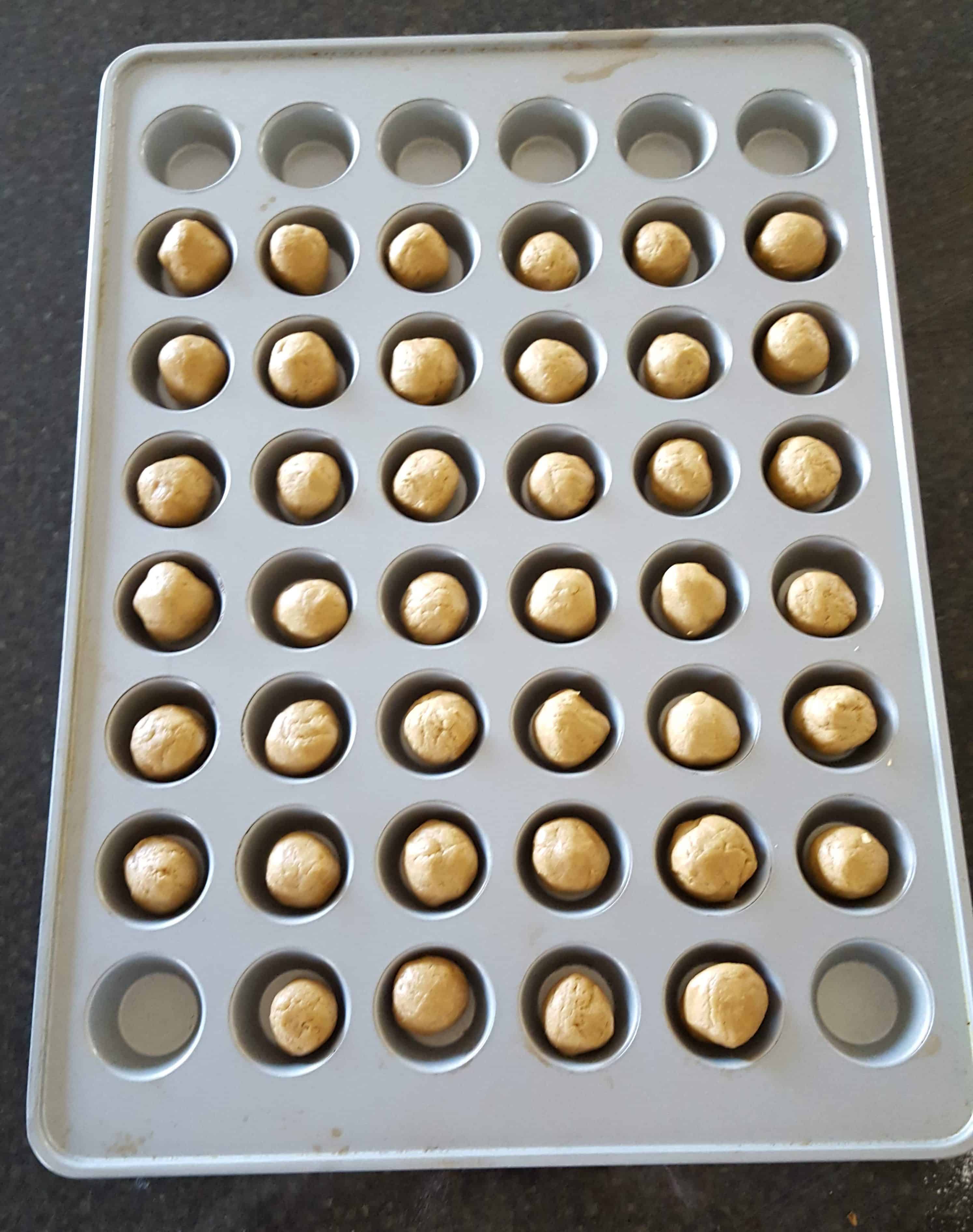 cookie dough balls in mini muffin tin