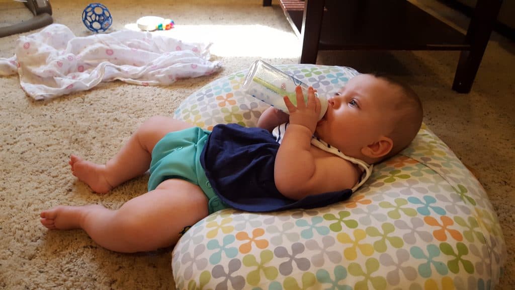 baby drinking a bottle watching tv