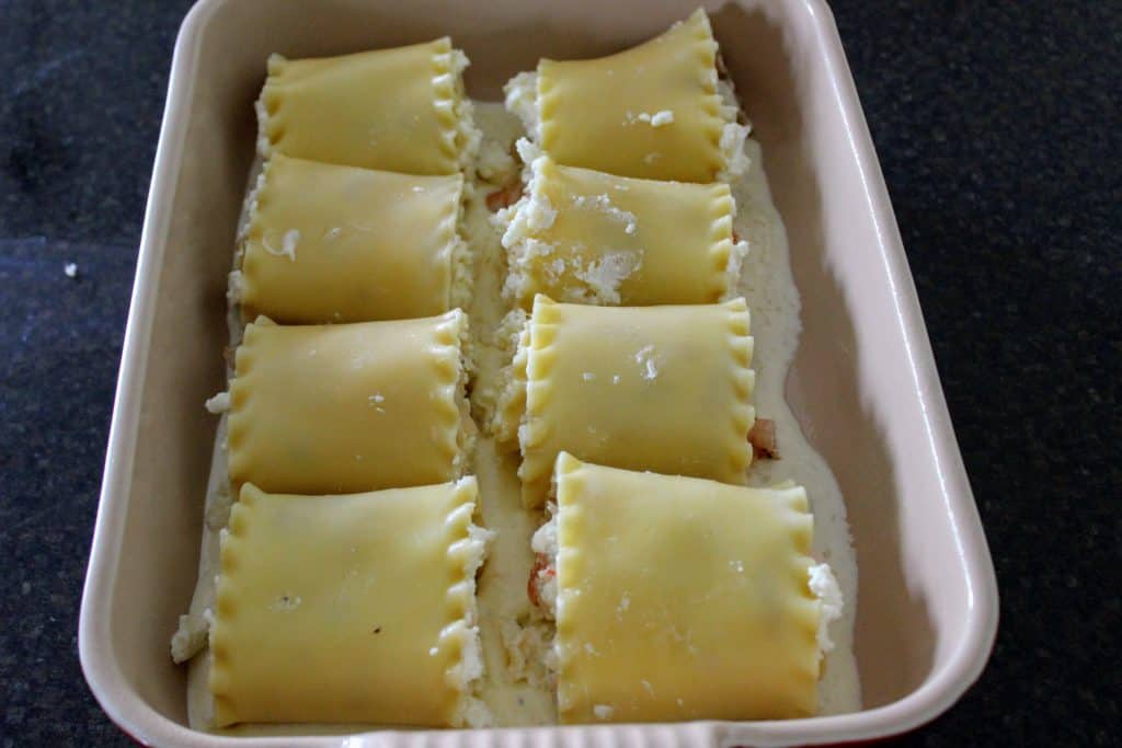 eight lasagna roll ups in a pan