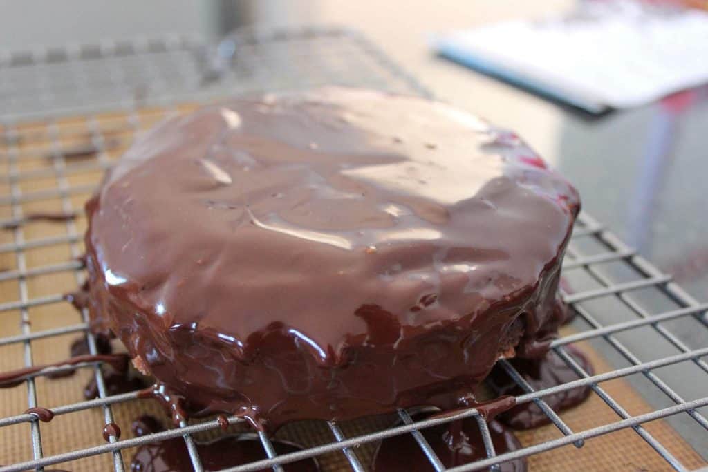 mini flourless cake covered in chocolate ganache