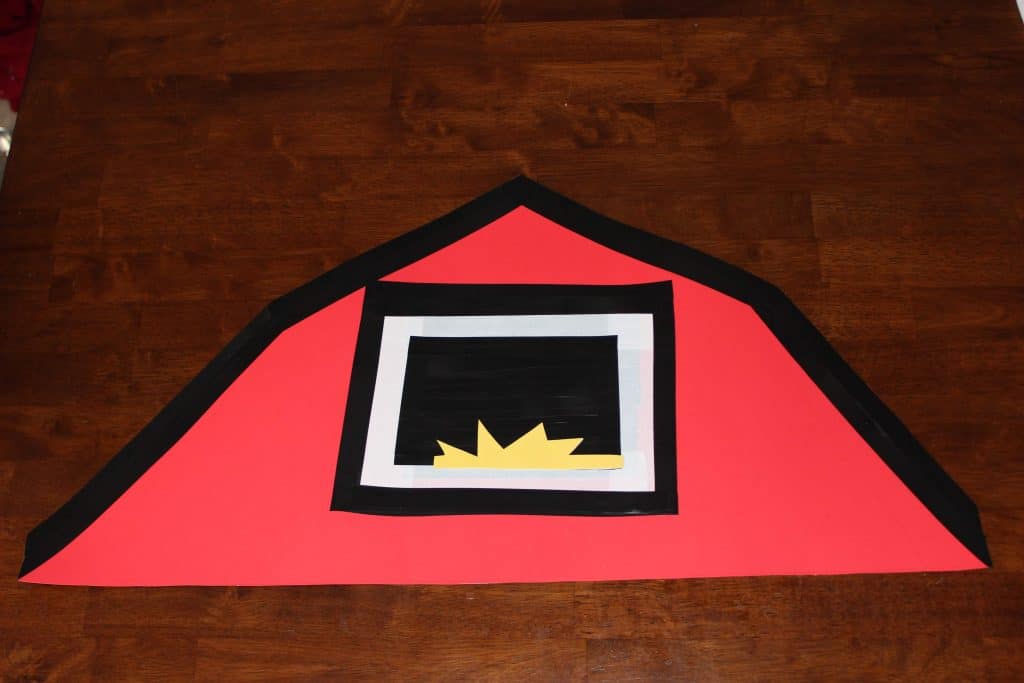 barn roof with window made of black and white tape and yellow paper