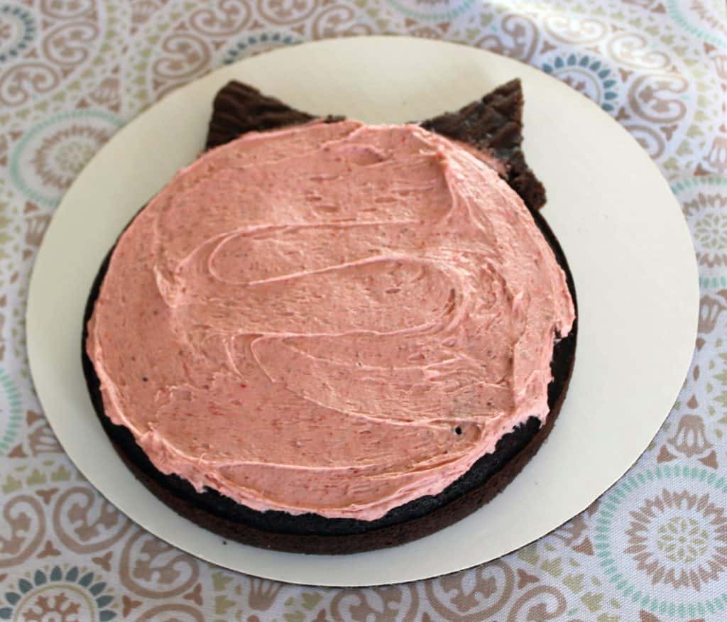 bottom layer of pig cake with pink strawberry filling