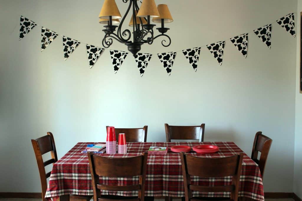 cow print banner over table with plaid tablecloth