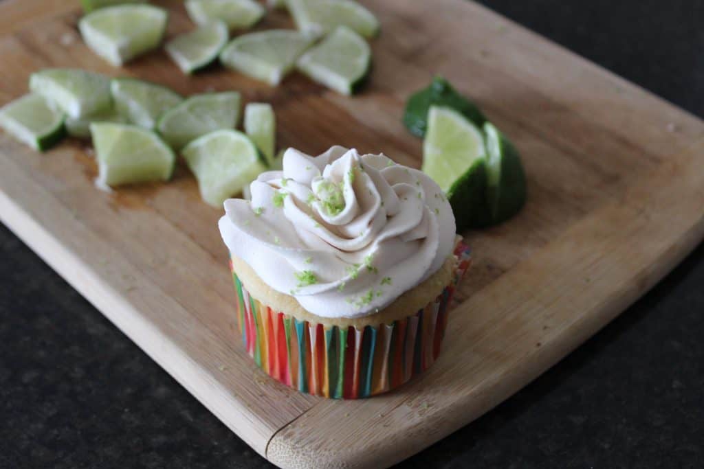 key lime pie cupcake on cutting board with lime trianges