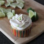 key lime pie cupcake on cutting board with lime trianges