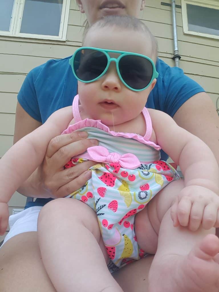 baby in sunglasses and a swimsuit