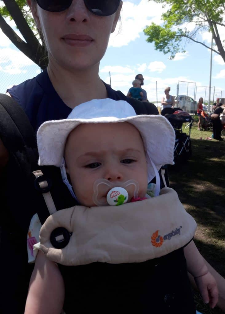 author wearing the baby in a carrier facing outward