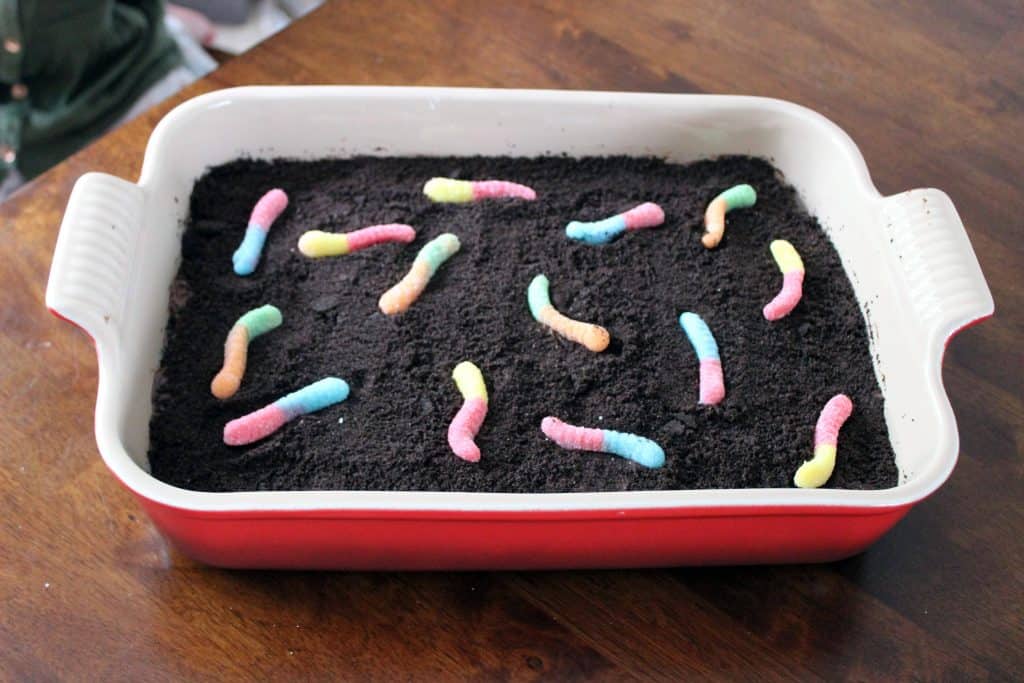 dirt cake rice krispie treats in 9x13 pan with sour candy worms on top