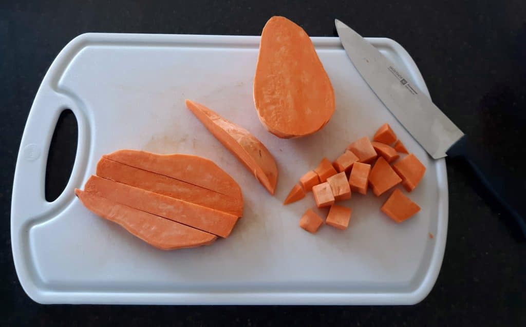 sweet potato on white cutting board, sliced and diced