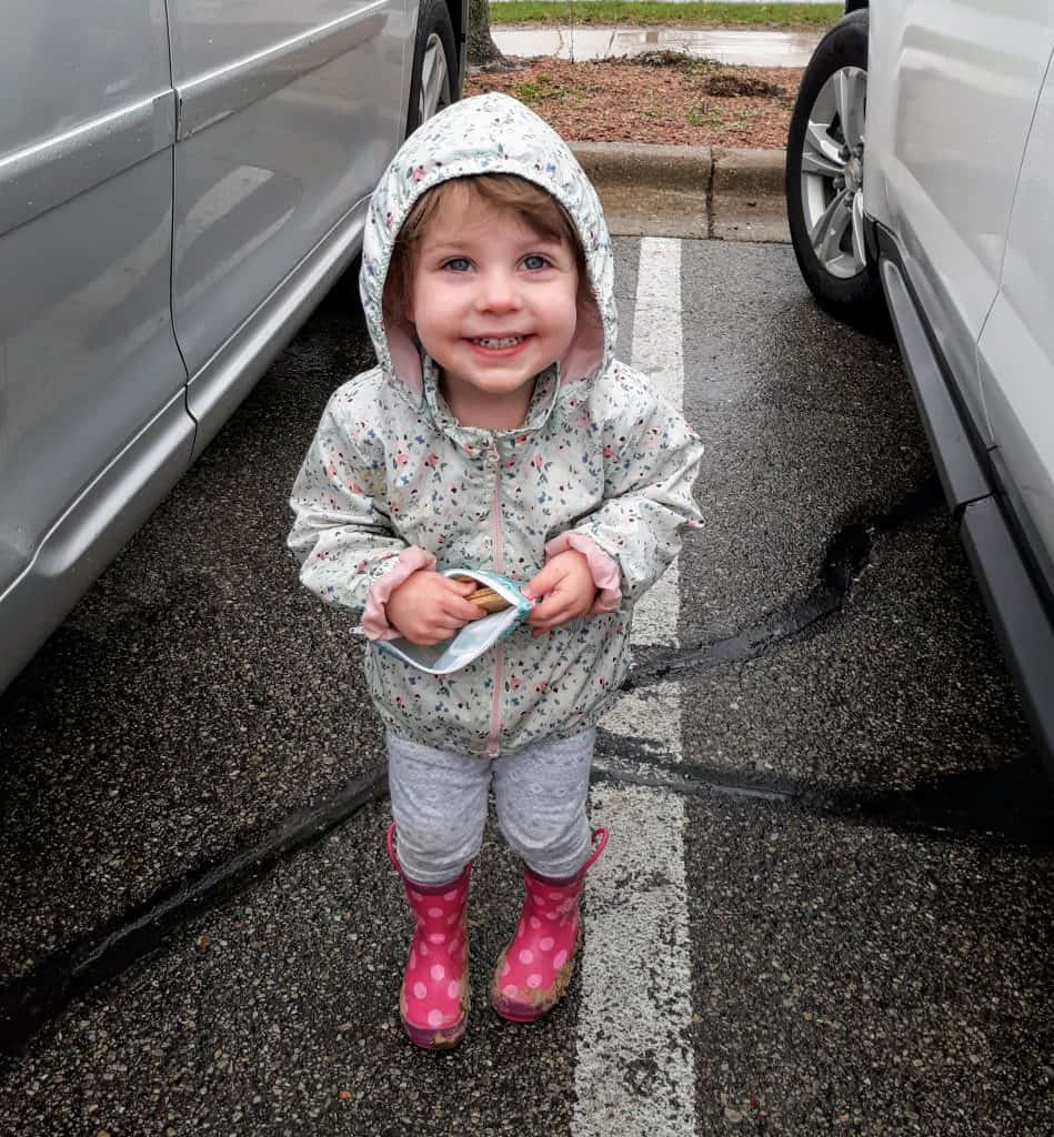 Toddler in rain boots and spring jacket