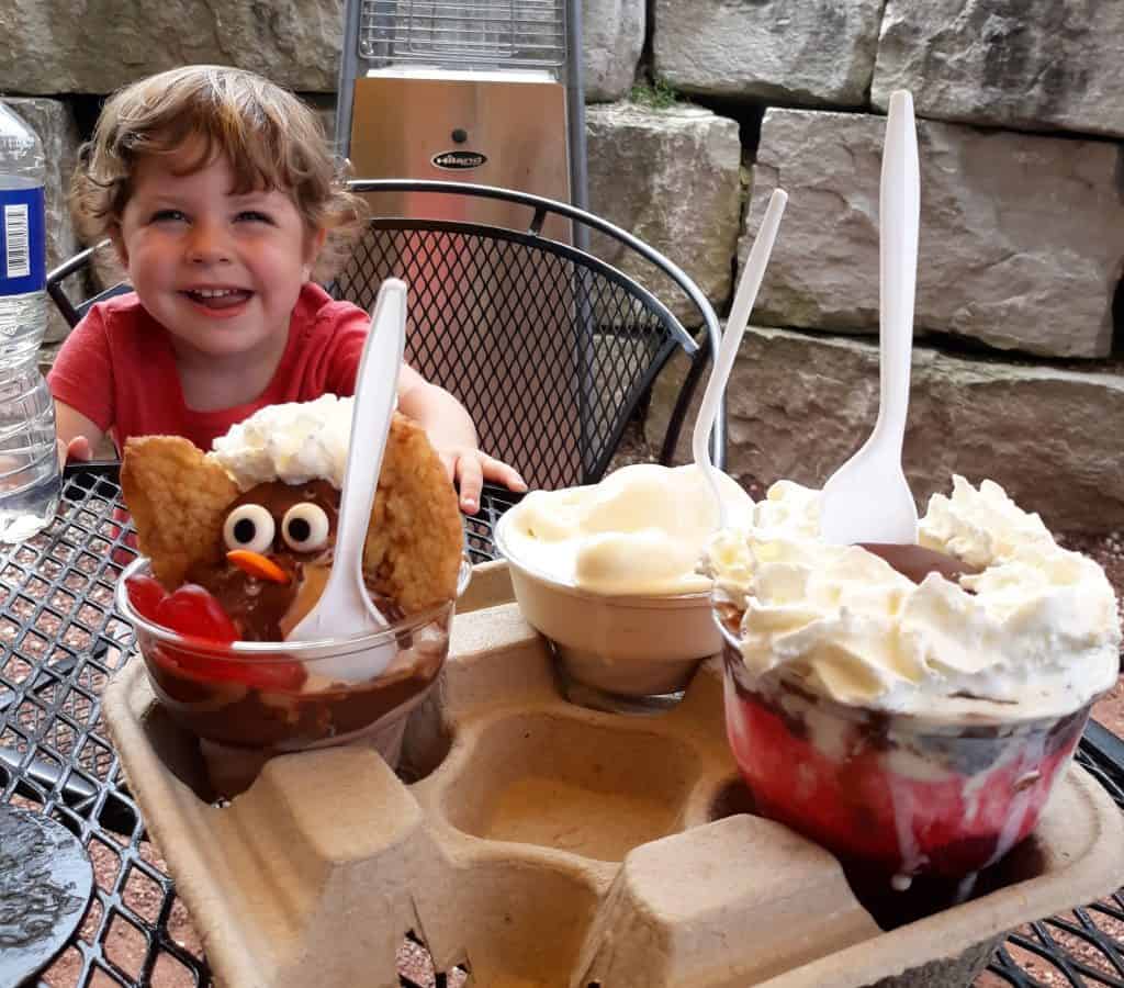 toddler with three sundaes