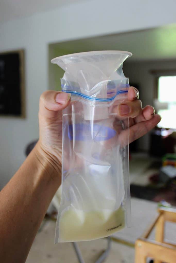 flange inserted into the top of a breastmilk storage bag creating a funnel