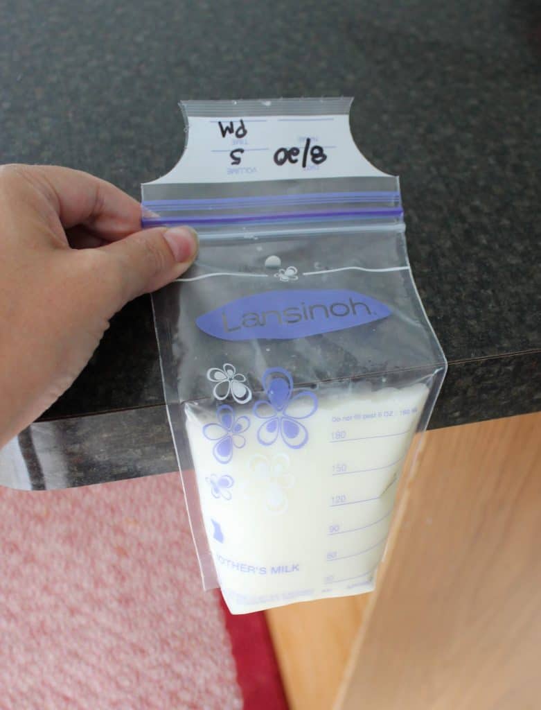 storage bag filled with breastmilk air being pushed out up against counter