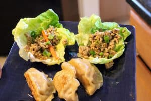 lettuce wraps and potstickers on blue plate