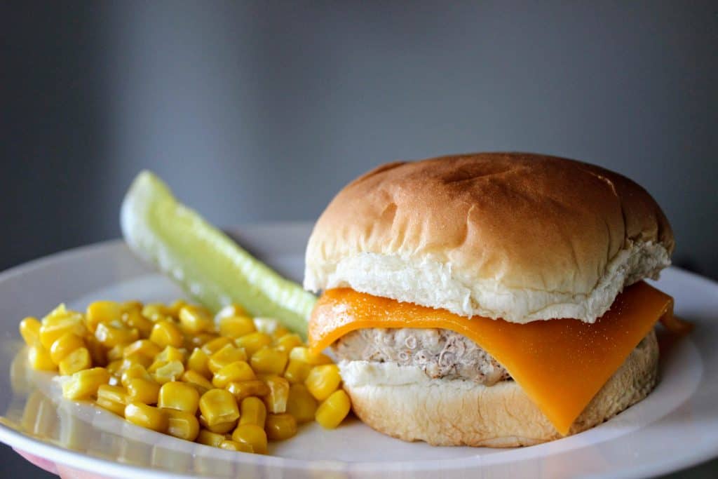 plate with turkey burger, corn and pickle