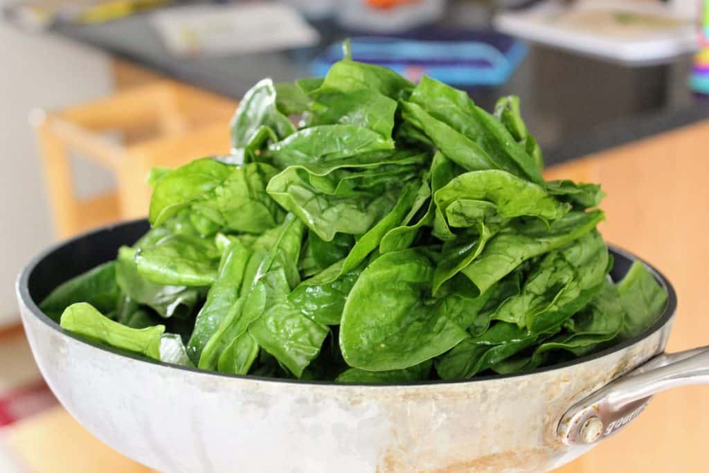 pan full of fresh spinach
