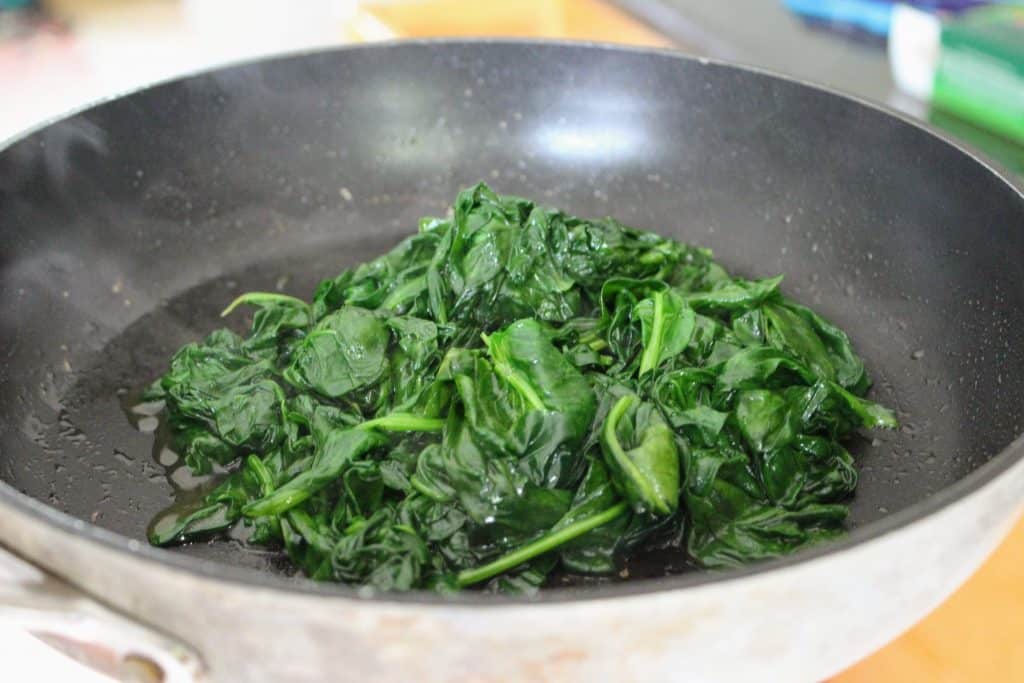 wilted spinach in a pan