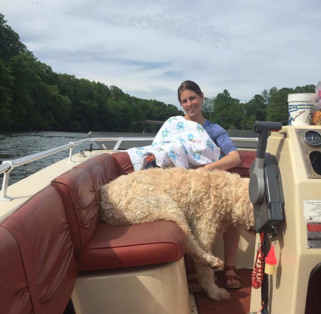 woman breastfeeding on a boat covered by blanket