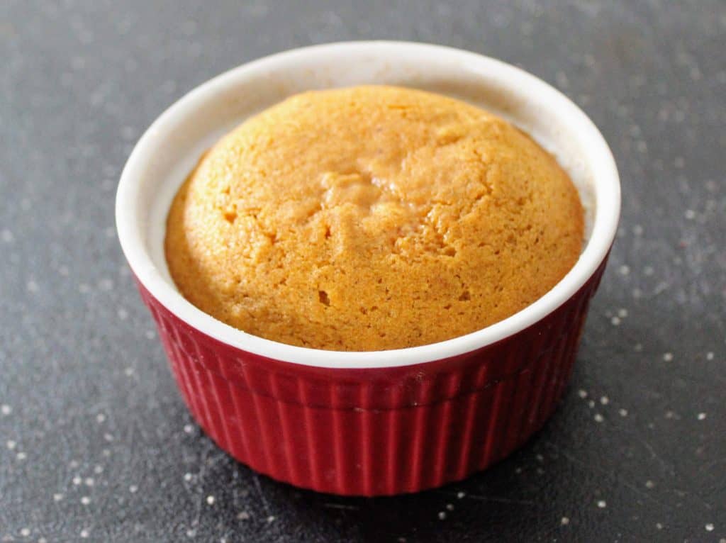 baked pumpkin caramel lava cake still in red ramekin