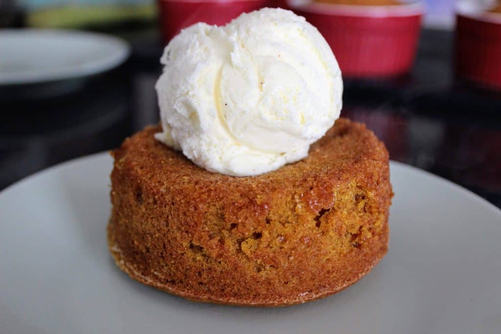 pumpkin caramel lava cake topped with ice cream on dessert plate 