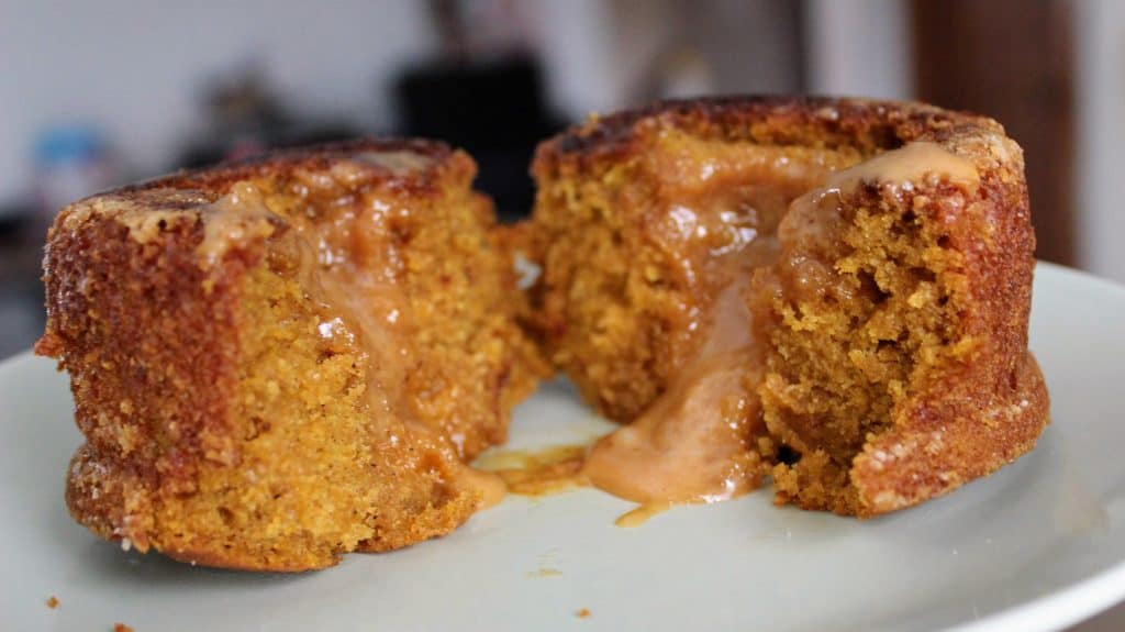pumpkin caramel lava cake cut in half with caramel oozing out of the center