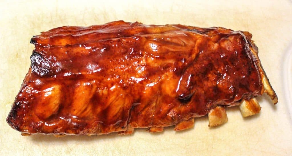 rack of ribs on white cutting board