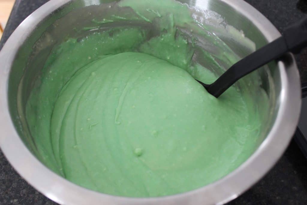 green cake batter in a mixing bowl