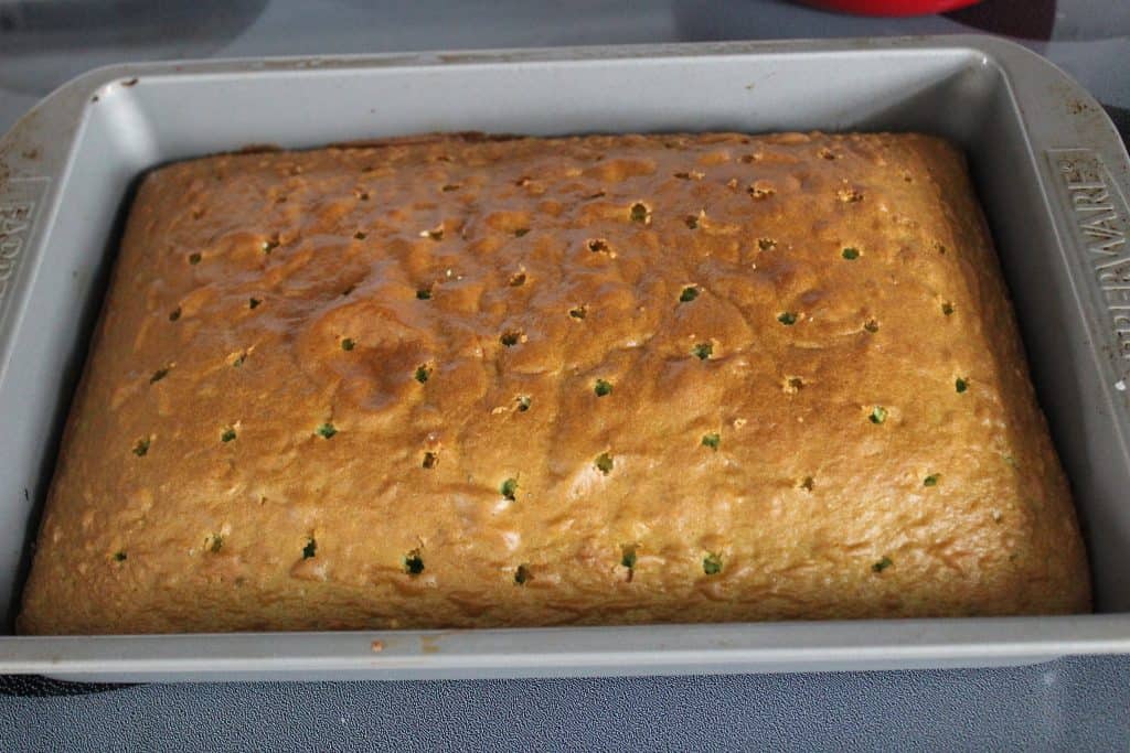 baked cake with a number of round holes poked in it