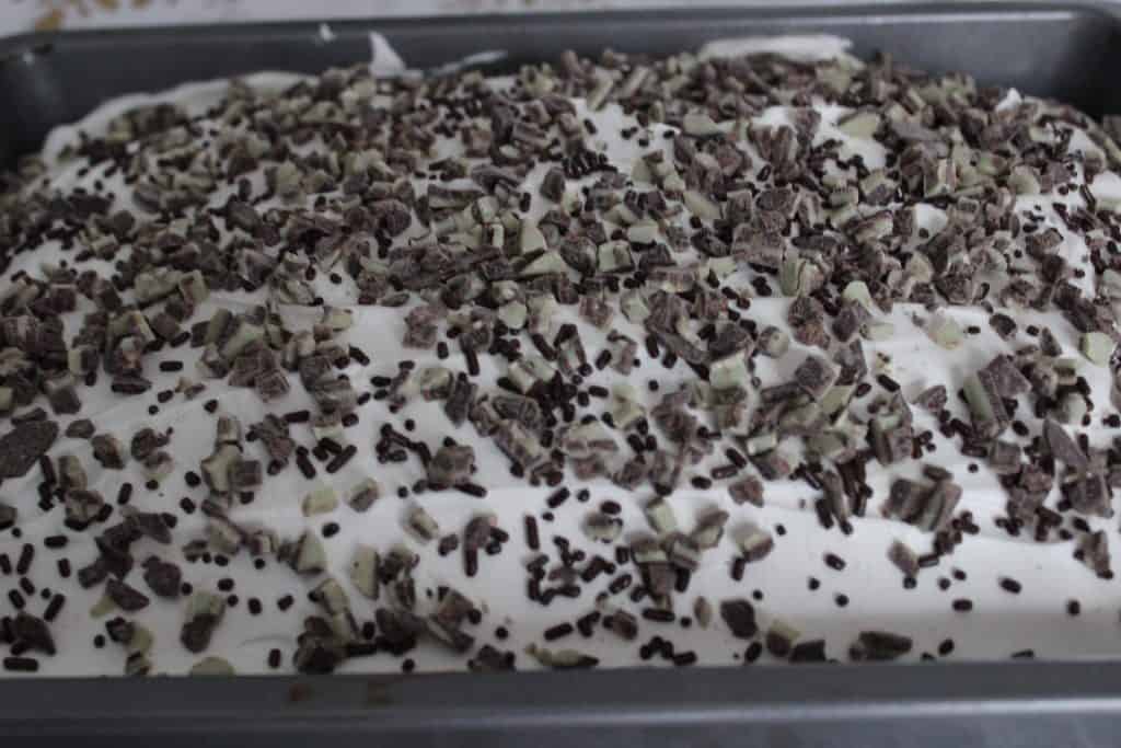 chocolate sprinkles and Andes baking chips sprinkled over Cool Whip
