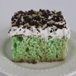 a square of cake on a white plate