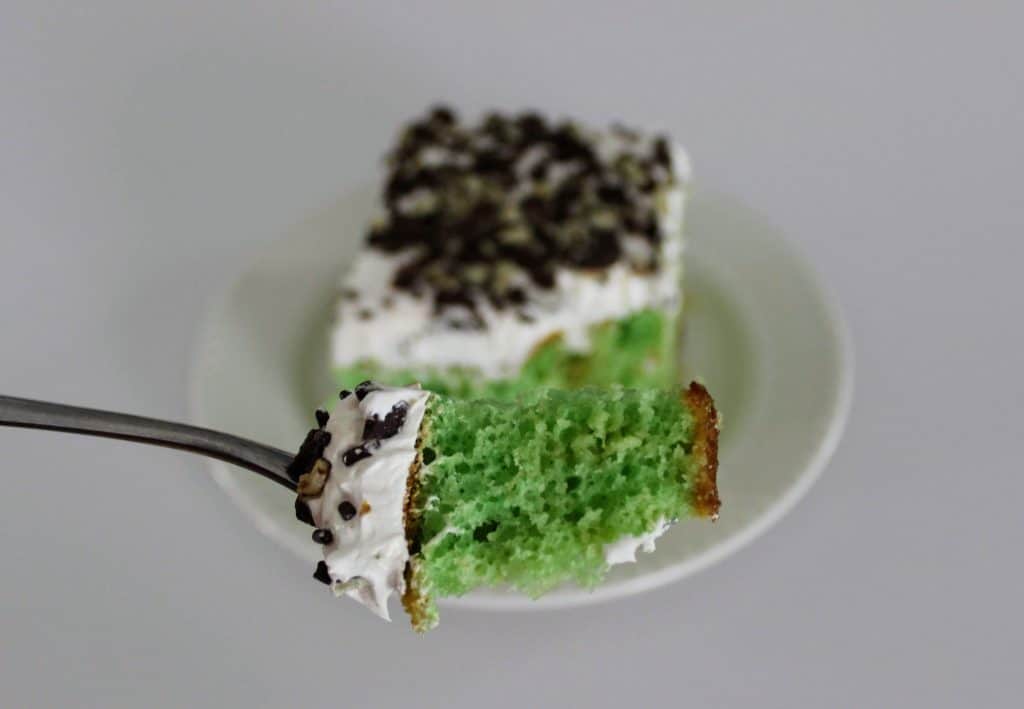 a square of cake on a white plate