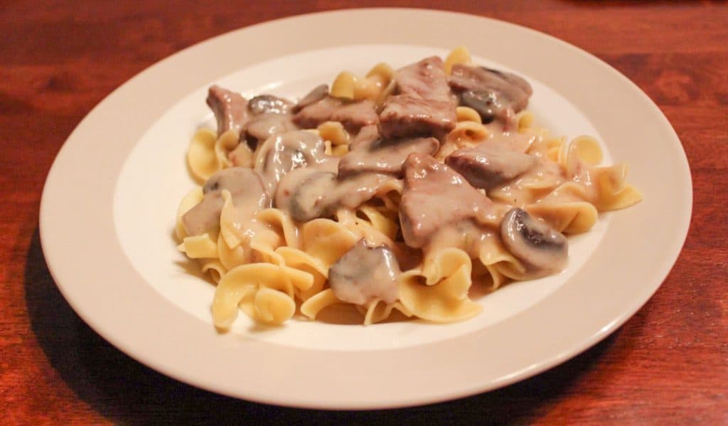 plate of egg noodles topped with stroganoff