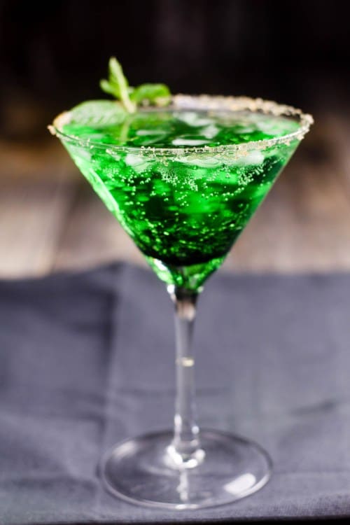 martini glass of frosted mint sour apple cocktail