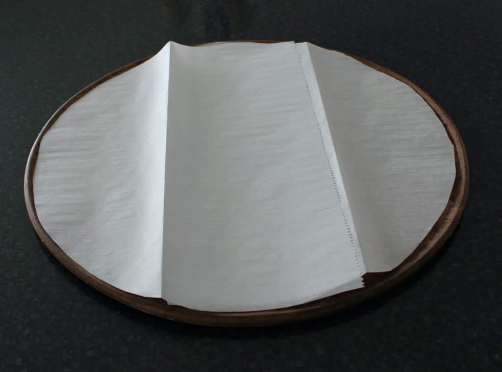 parchment paper circle on pizza stone
