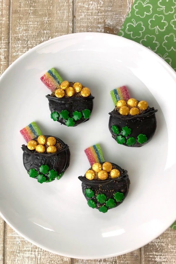 Oreo cookies decorated like pots of gold with rainbow candy attached