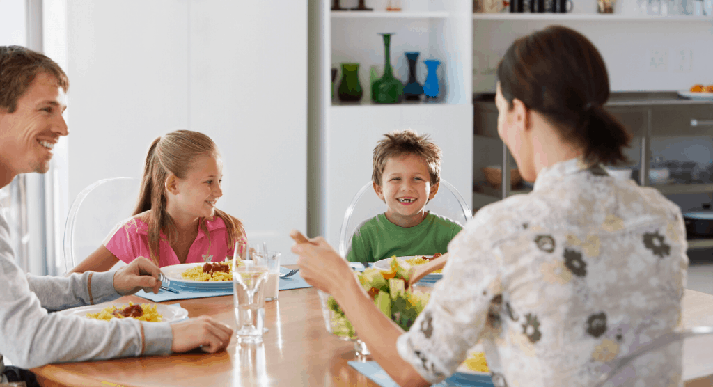 family sitting down at dinner table