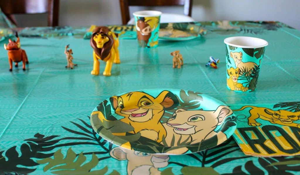 Lion King table cloth, paper plate, cup, and figurines